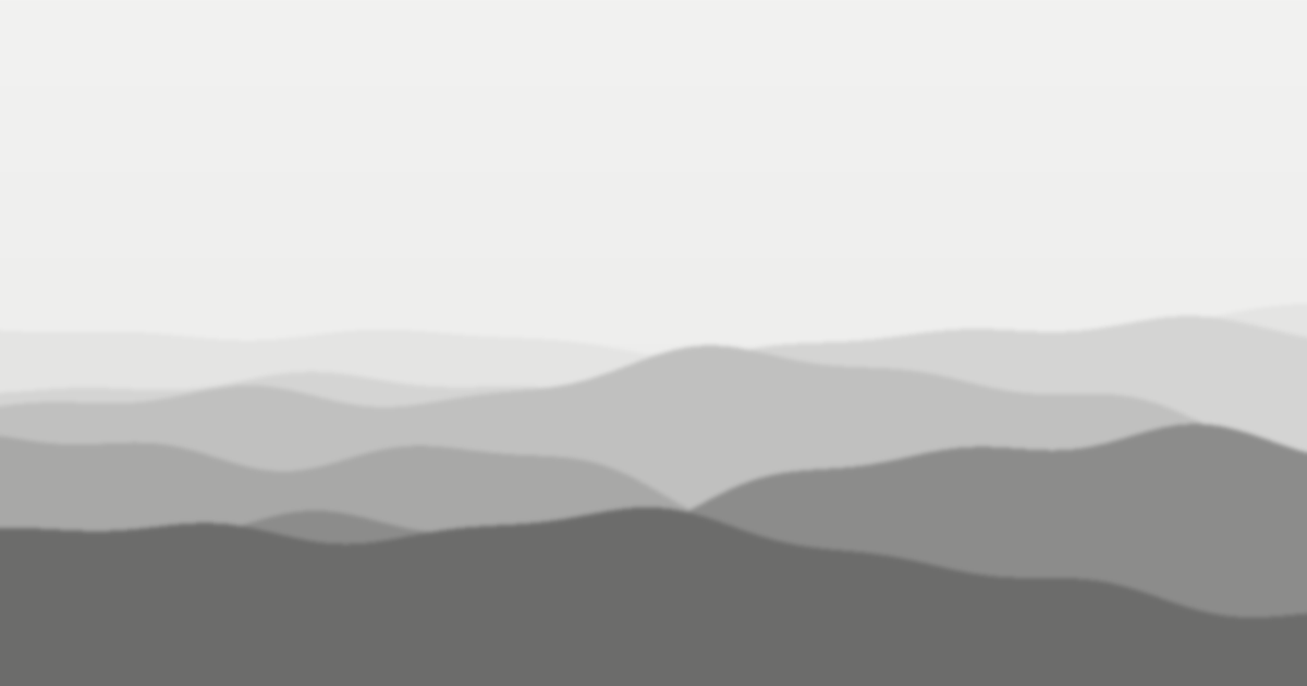 Layered mountain ridges fading into mist in black and white